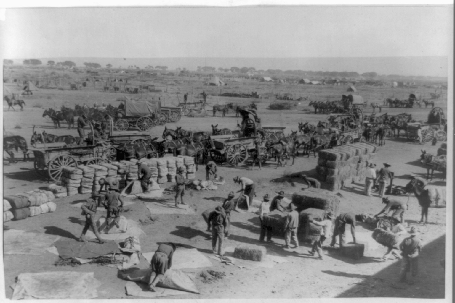 [U.S. Army Punitive Expedition after Villa, Colonia Dublan, Mexico, 1916. American Headquarters: Unloading supplies from Mexican train which has come from Juarez on the border], c1916. — historic photograph