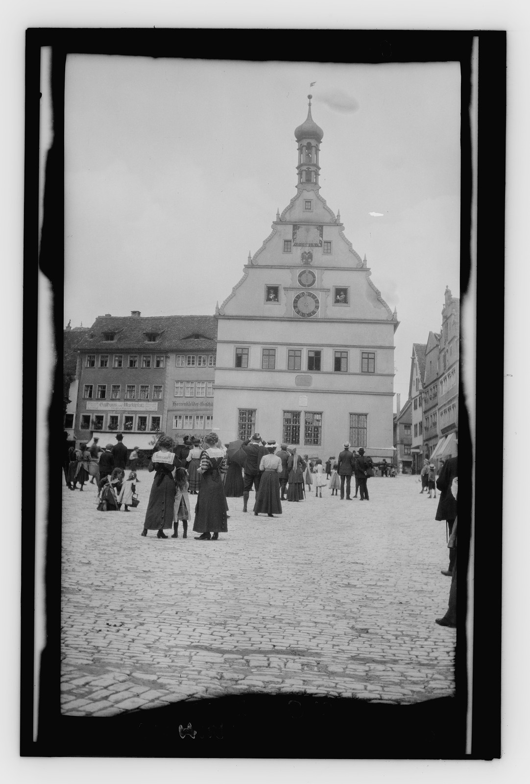 Crowd watching post office clock. Rothenburg, n/a — historic photograph