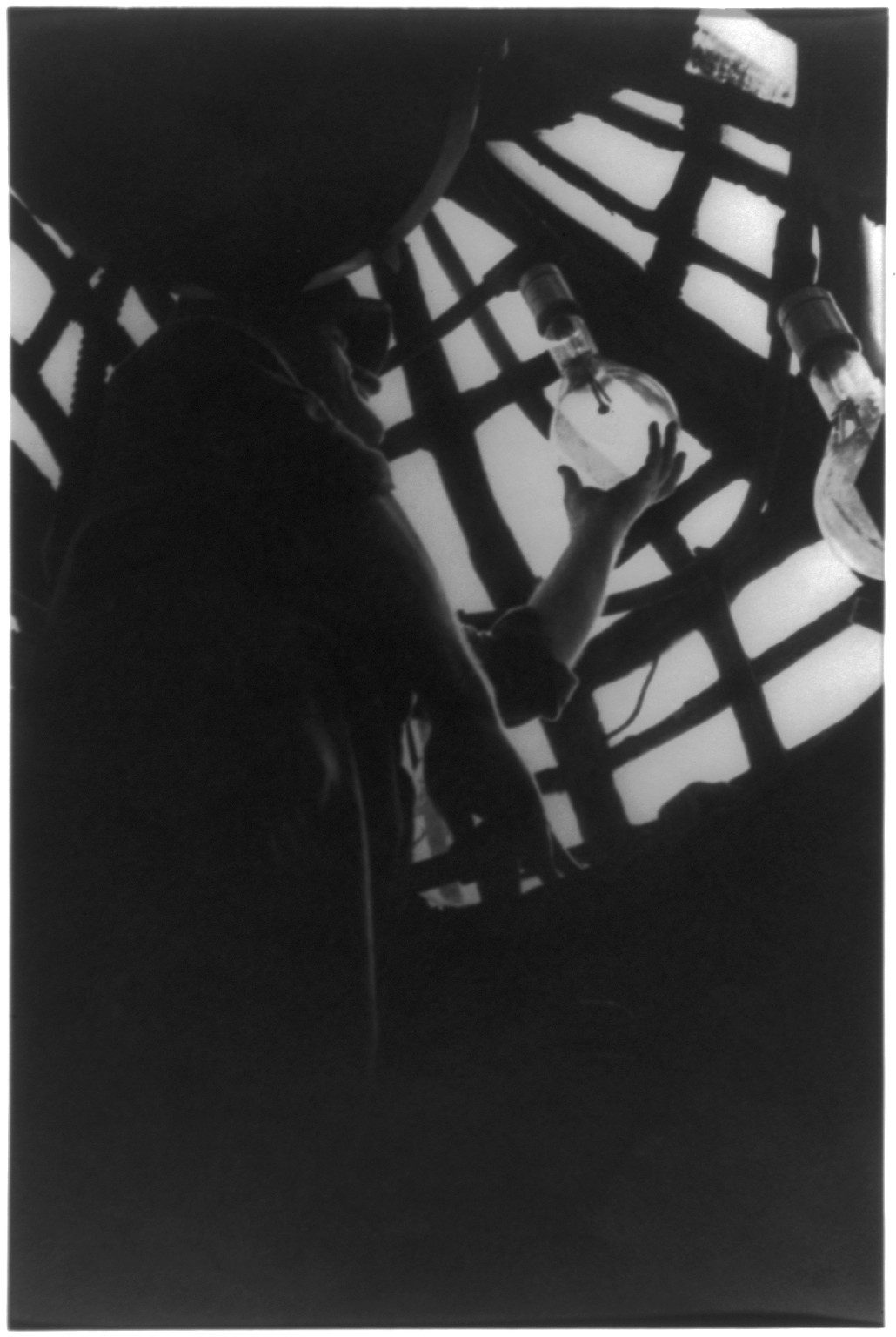 [Statue of Liberty: Man replacing light bulb inside (III, 6)], [no date recorded on caption card] — historic photograph