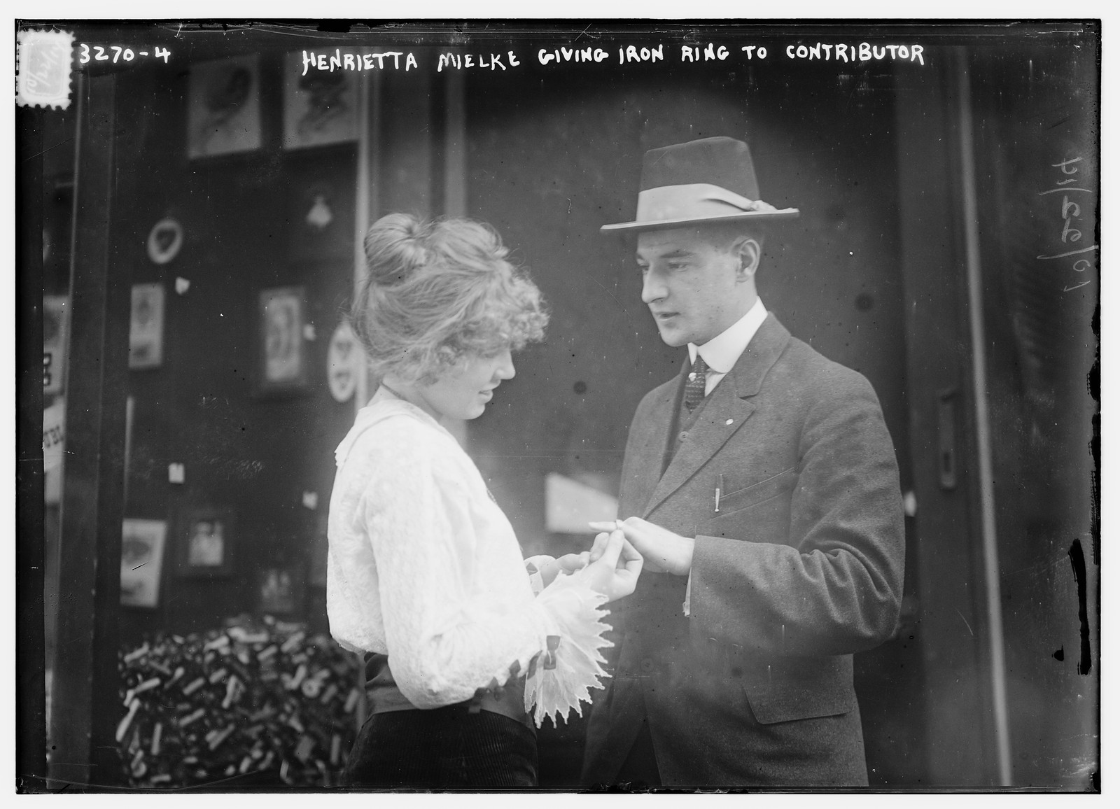 Henrietta Mielke giving iron ring to contributor, n/a — historic photograph