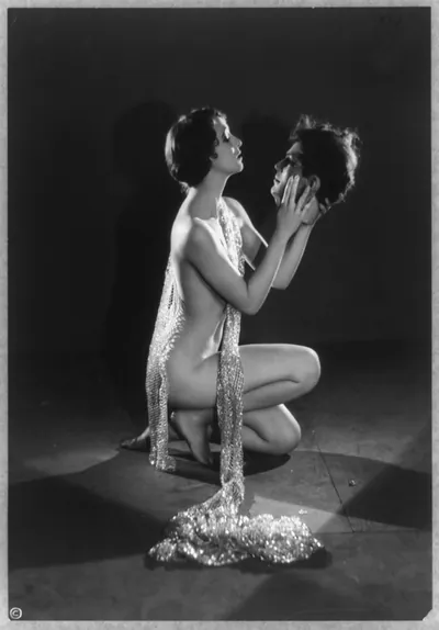 [Mack Sennett comedy films--nude young woman kneeling and holding model of head of man]