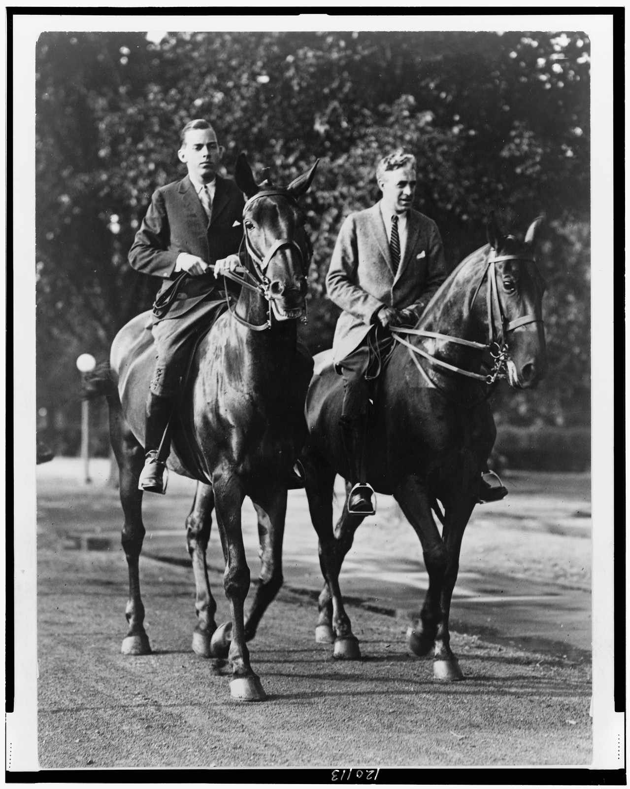 [John Coolidge on horseback, with another rider, probably Secret Service agent Jim Haley], [between 1920 and 1940] — historic photograph