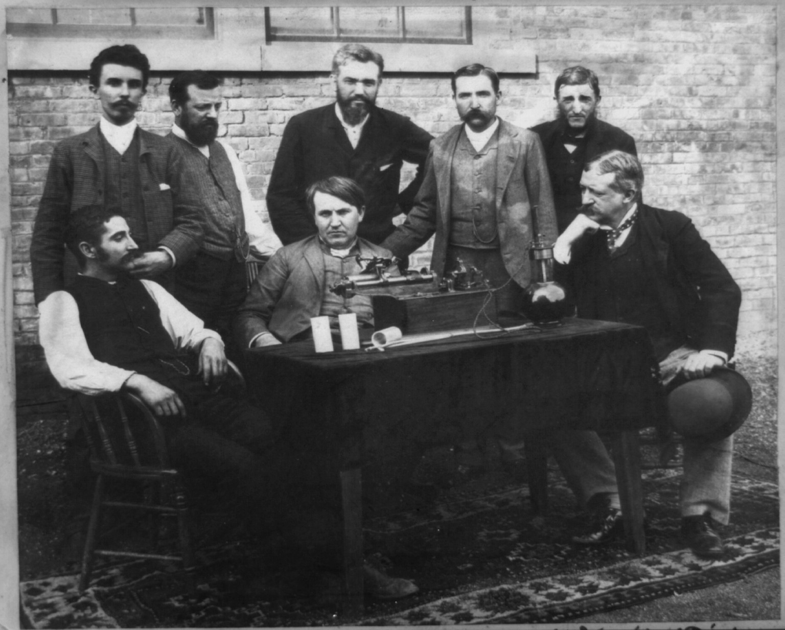 [Thomas A. Edison, W.K.L. Dickson, and others at the perfected" wax-recording phonograph]", c1892. — historic photograph