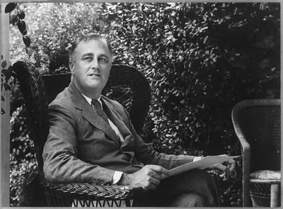 [Franklin D. Roosevelt, three quarters length portrait, seated on porch, facing right]