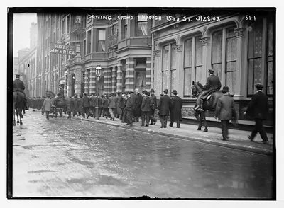 Police driving crowd through 15th St., New York