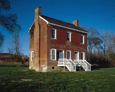 Two-story brick house with white porch and steps