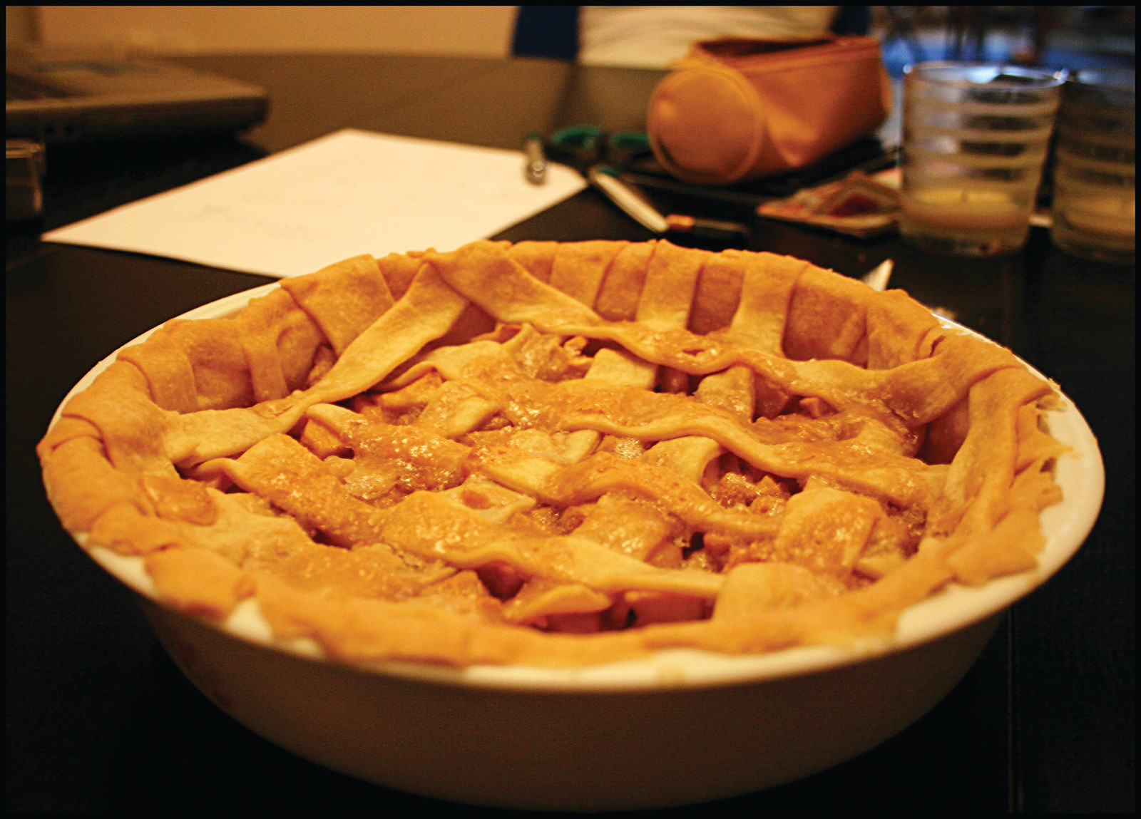 Apple pie with lattice crust in a white dish — historic image