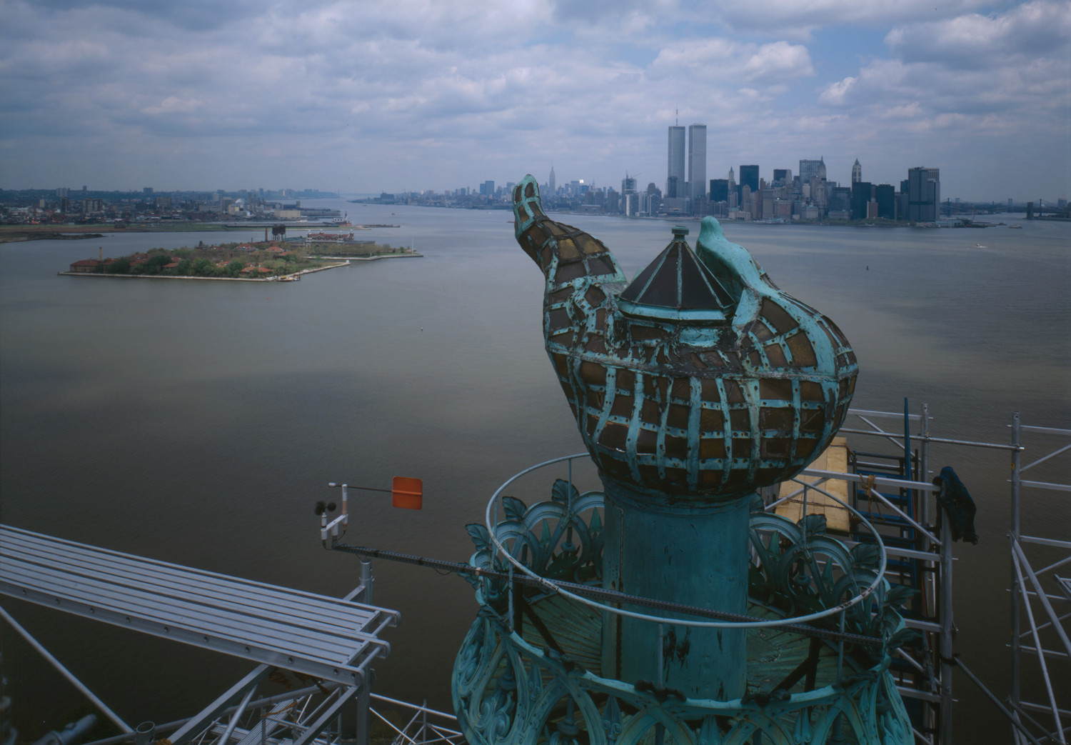 Statue of Liberty torch above harbor and Manhattan skyline — historic image