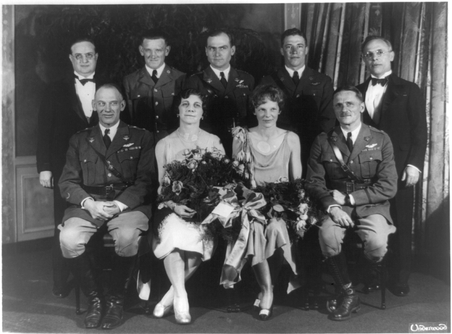 [Carl Spaatz and Amelia Earhart posed with seven other people], [between ca. 1928 and 1937] — historic photograph