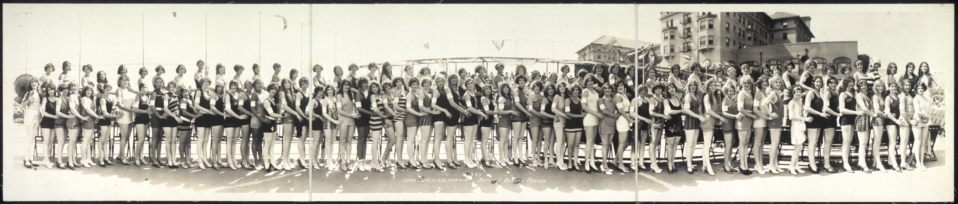 Panoramic photograph of women in bathing suits on a beach — historic photograph