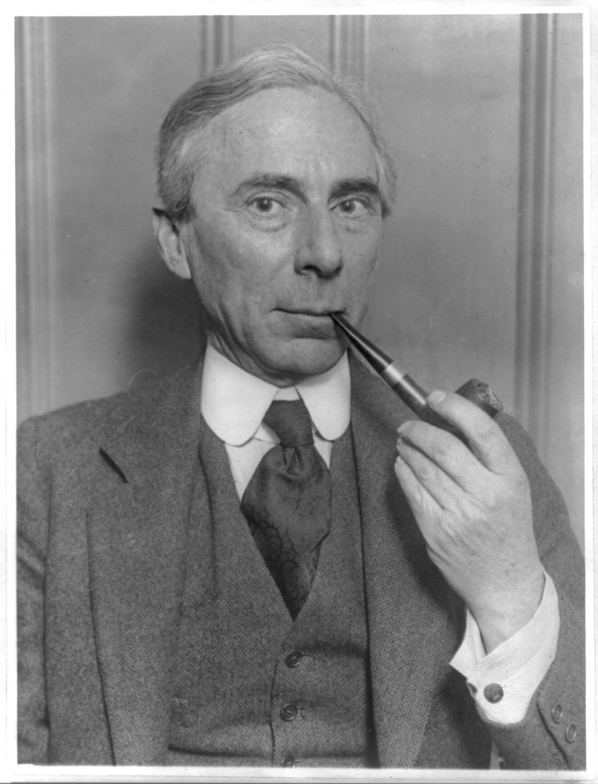 [Bertrand Russell, bust, facing right, smoking pipe] — historic photograph