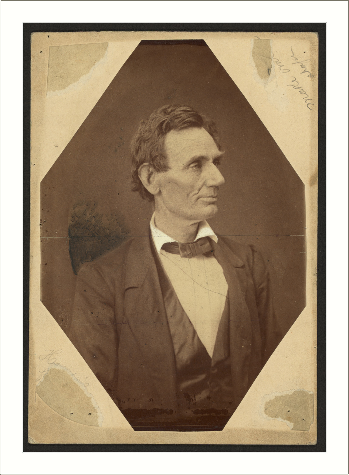 Sepia studio portrait of a man in dark jacket and bow tie — historic image