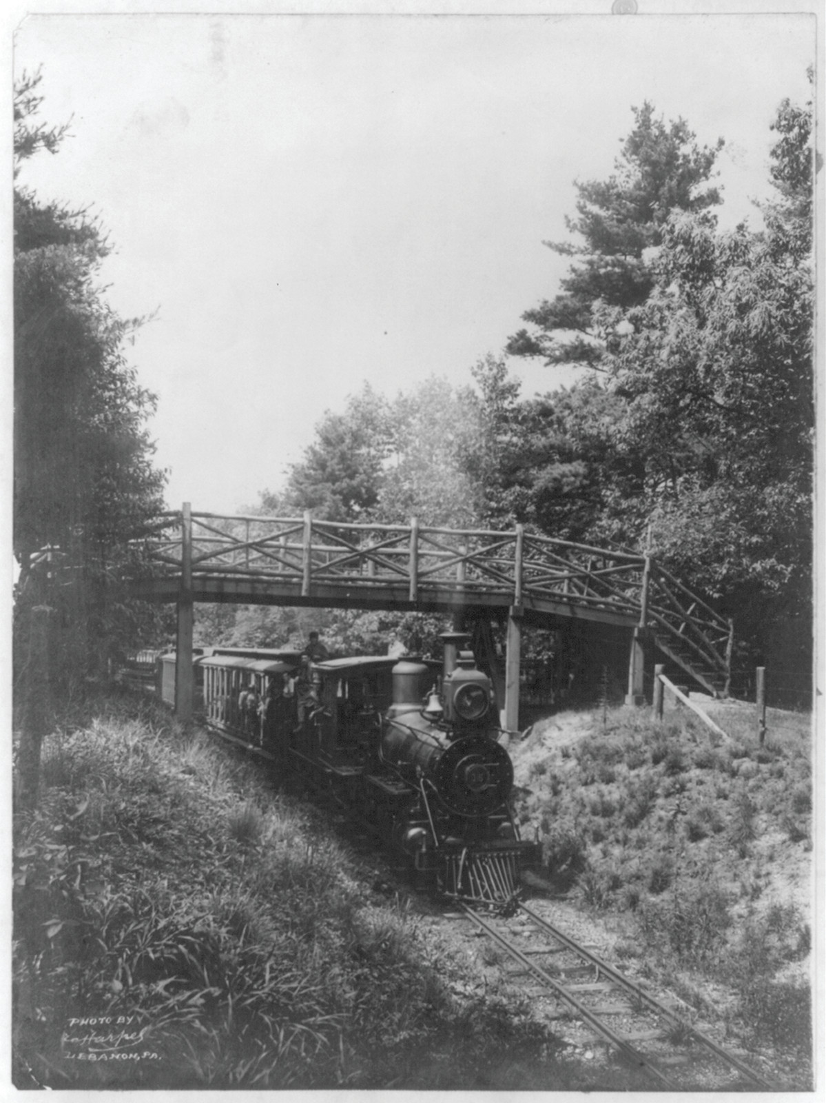 [Railroad train passing under bridge, with the locomotive in foregrd., near Lebanon, Pa. (?), [no date recorded on caption card] — historic photograph