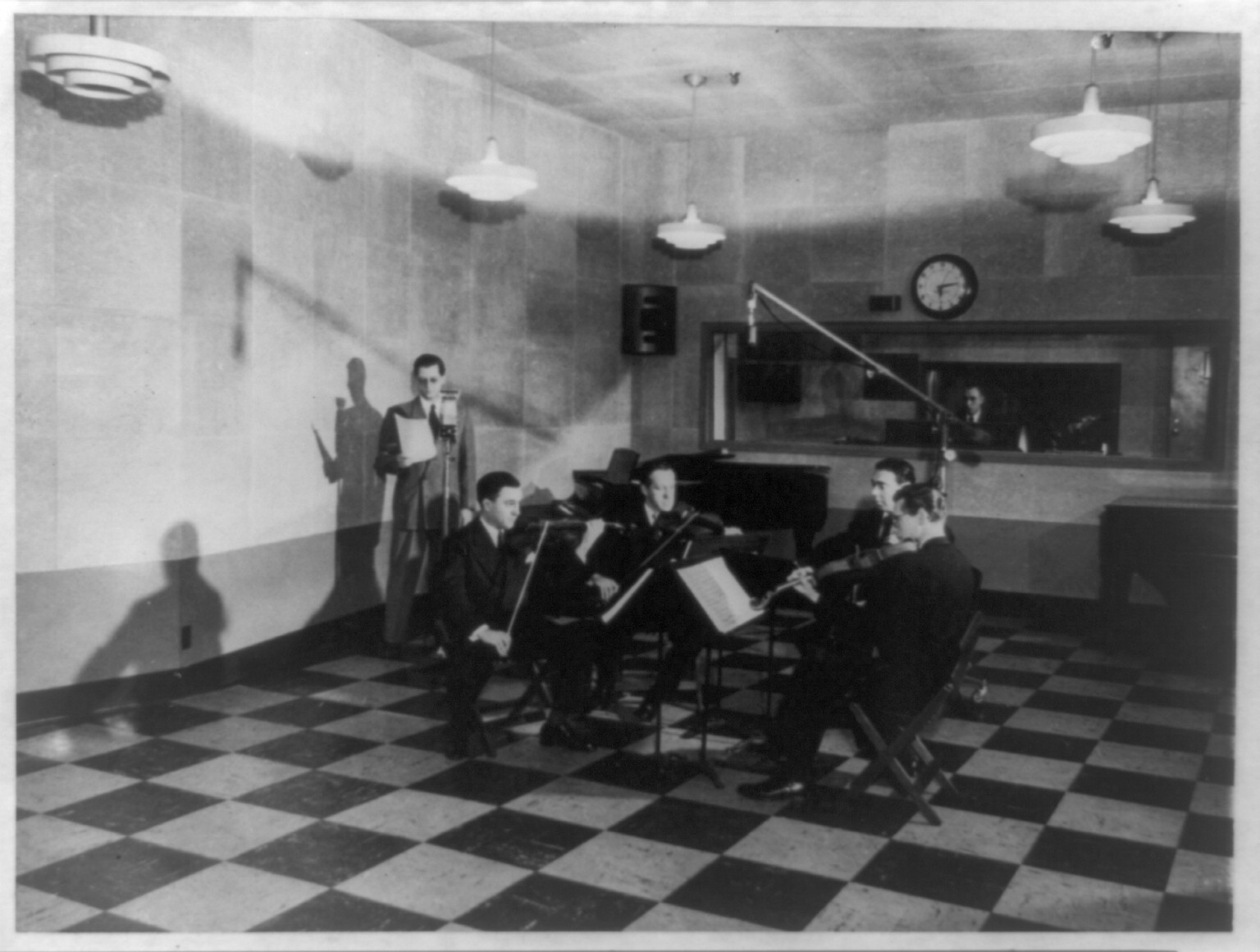 WQXR broadcasting in N.Y. Times Building--The WQXR string quartet broadcasting its first program in one of the new studios, 1950 April 16. — historic photograph