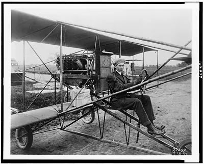 [Glenn Martin delivering newspapers in his airplane, Los Angeles]