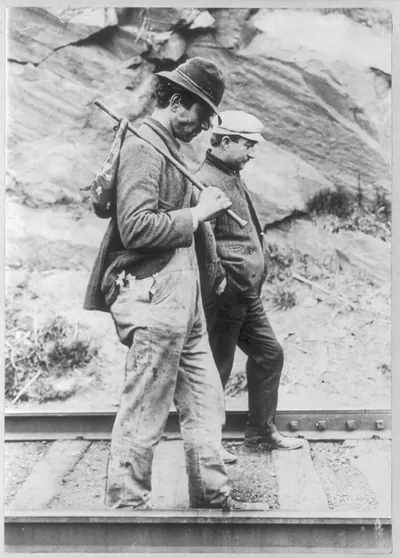 [Two hobos walking along railroad tracks, after being put off a train]