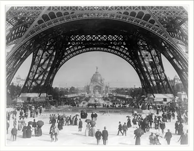 Paris Exposition, view from ground level of the Eiffel tower with Parisians promenading