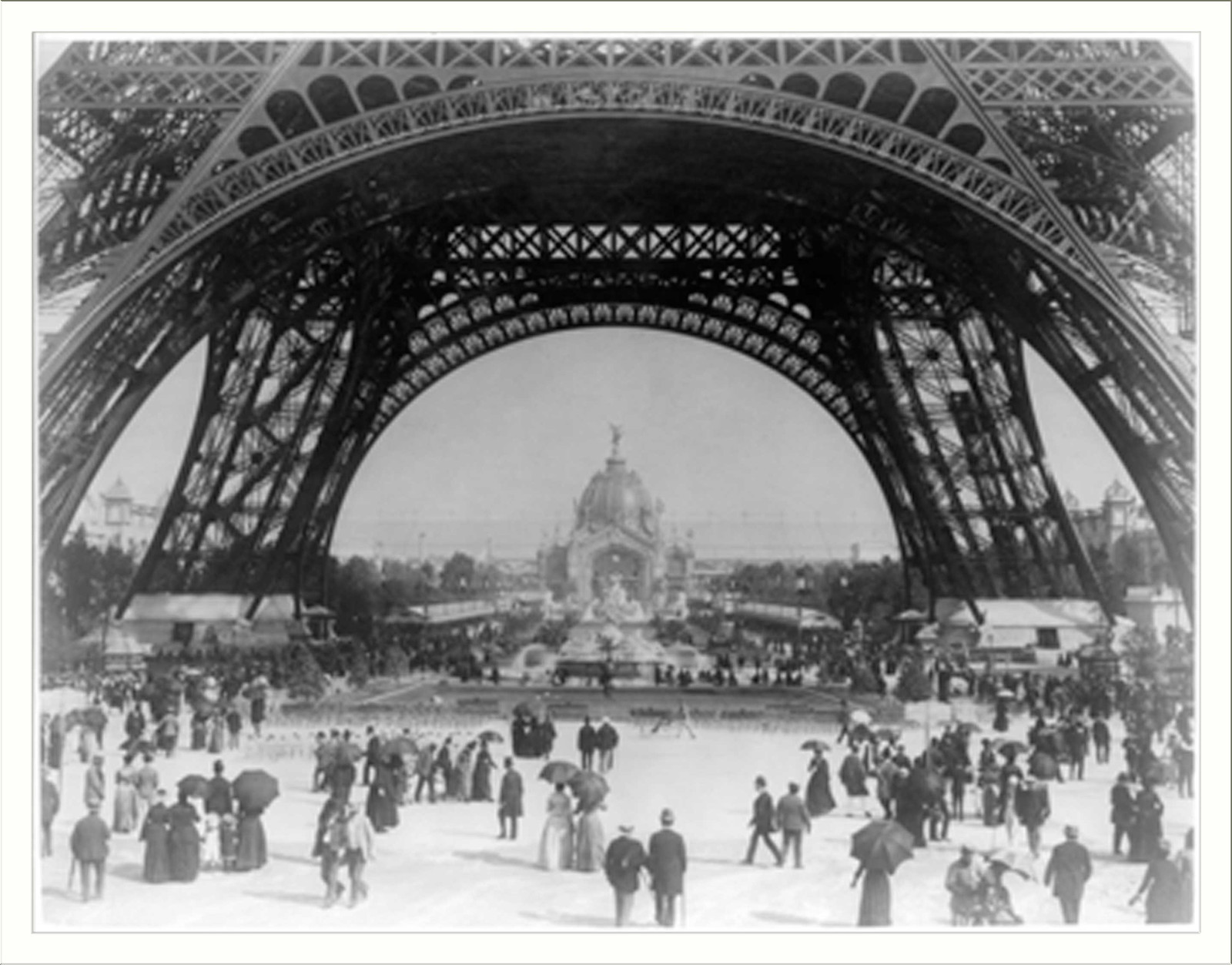 Paris Exposition, view from ground level of the Eiffel tower with Parisians promenading, [between 1887 and 1889] — historic photograph
