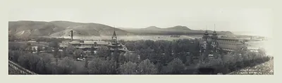 Panoramic photograph of a town with factory buildings and hills