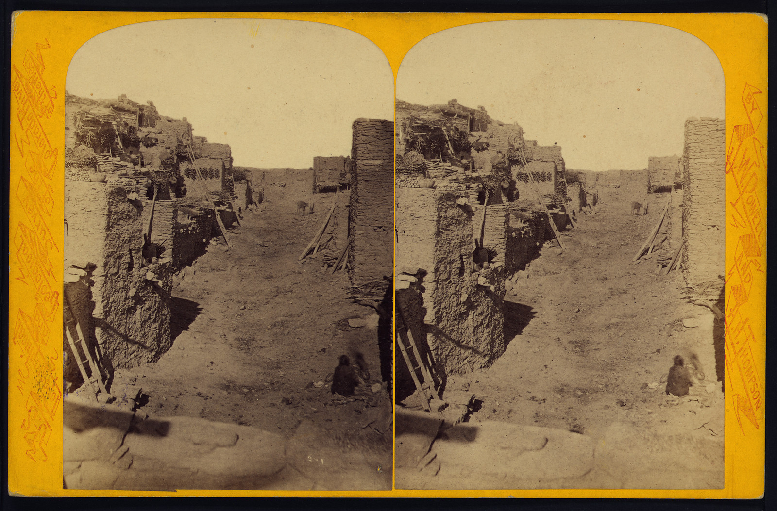 Stereoview of an adobe pueblo street with ladders — stereograph