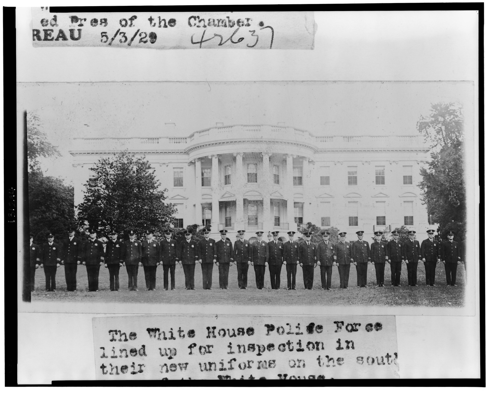 The White House police force lined up for inspection in their new uniforms on the south lawn of the White House, 1929 May 3. — historic photograph
