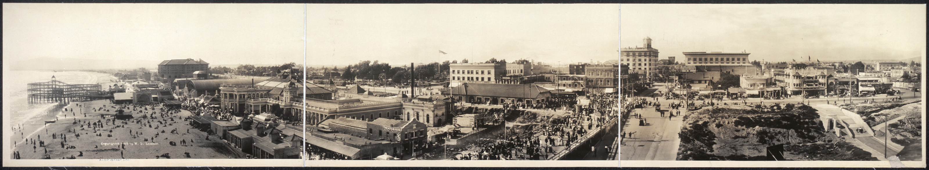 Panoramic view of a seaside resort with pier and crowded beach — historic image