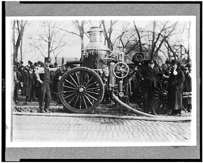 [Two firemen with fire engine]