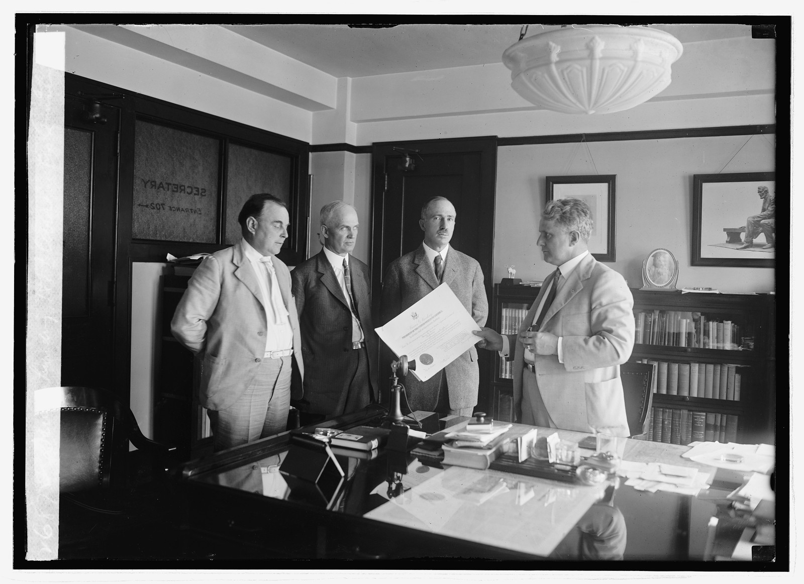 Davis handing H.A. Curran his commission, 6/16/23, [19]23 June 16. — historic photograph