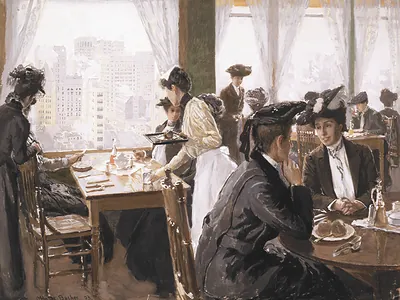 Women dining in a restaurant overlooking city skyscrapers