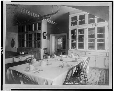 [White House kitchen with set table and cupboards]
