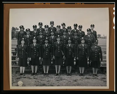 Women in Army Corps uniforms, group portrait on bleachers