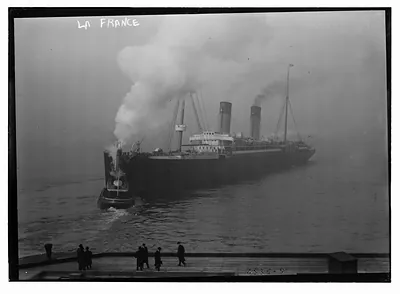 LA FRANCE w/ tug boat in harbor