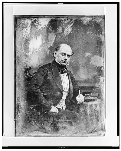 [Forbes Winslow, three-quarter length portrait, three-quarters to the right, eyes front, seated in chair at table with escritoire, holding quill pen]