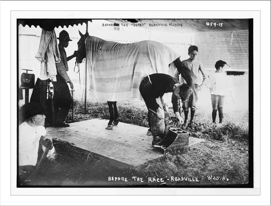 Blacksmith shoeing horse before the derby, Readville, 8/25/08. — historic photograph