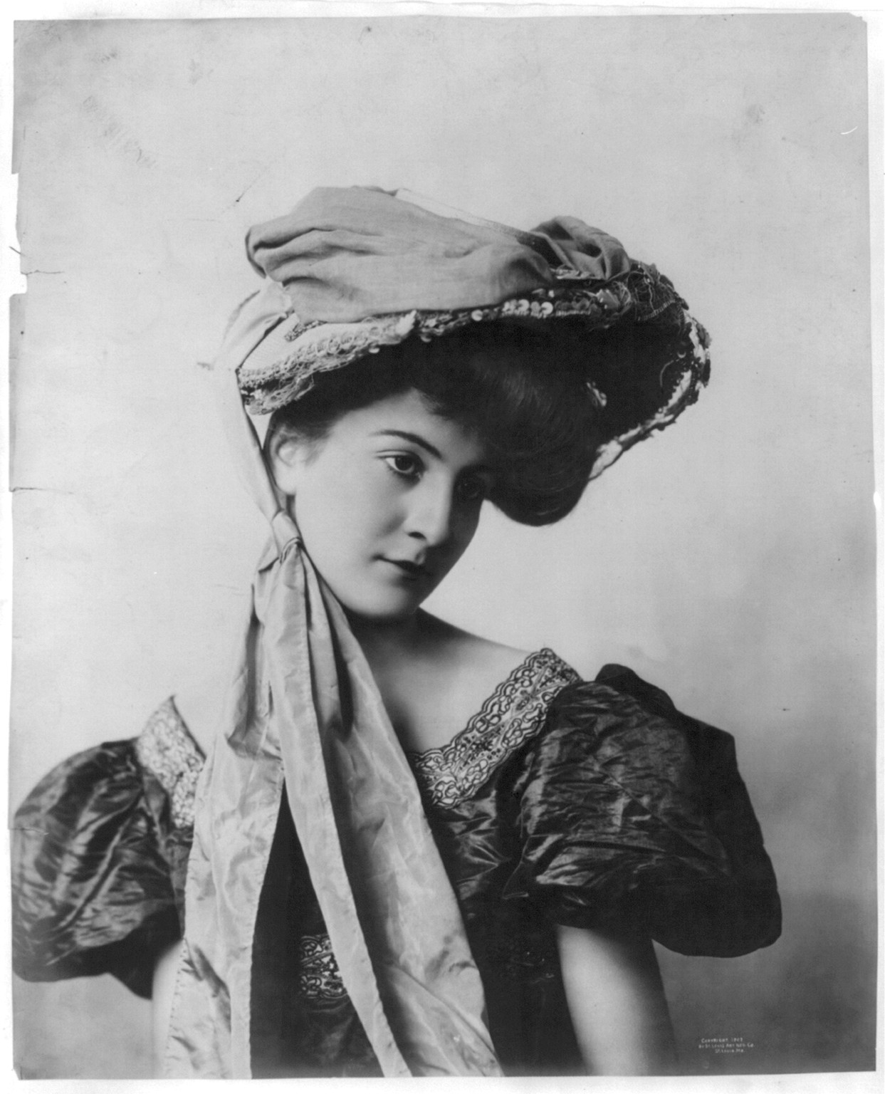 [Young woman modeling: Half lgth., 2 long pieces of material draped from hat over body], c1903. — historic photograph