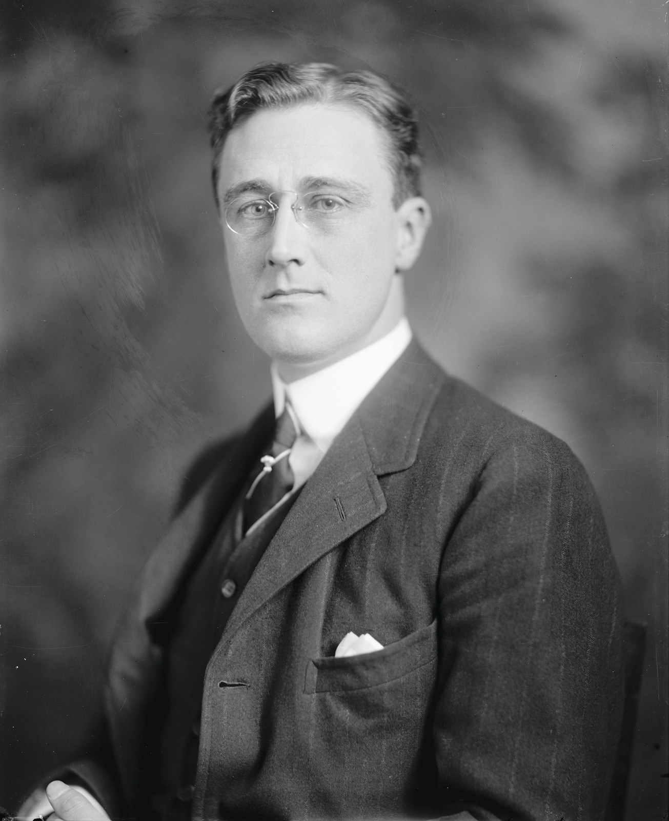 Studio portrait of a man in suit and pince-nez — historic image