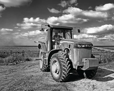 Black and white tractor in a flat field