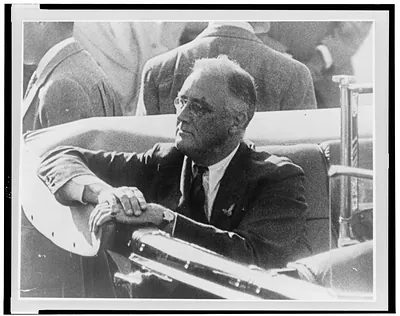 [Franklin D. Roosevelt, half-length portrait, seated in automobile, facing left]