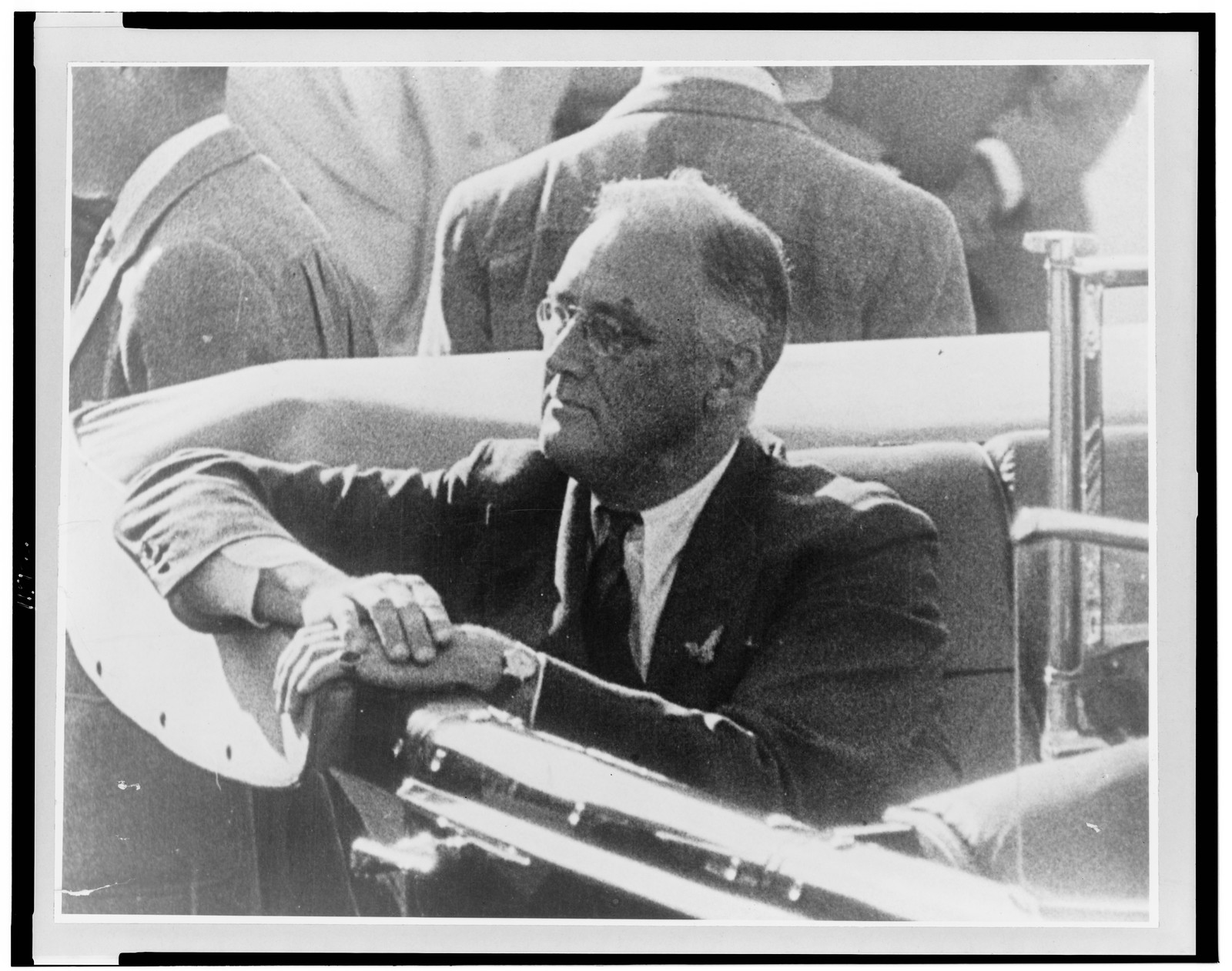 [Franklin D. Roosevelt, half-length portrait, seated in automobile, facing left], [between 1933 and 1943] — historic photograph