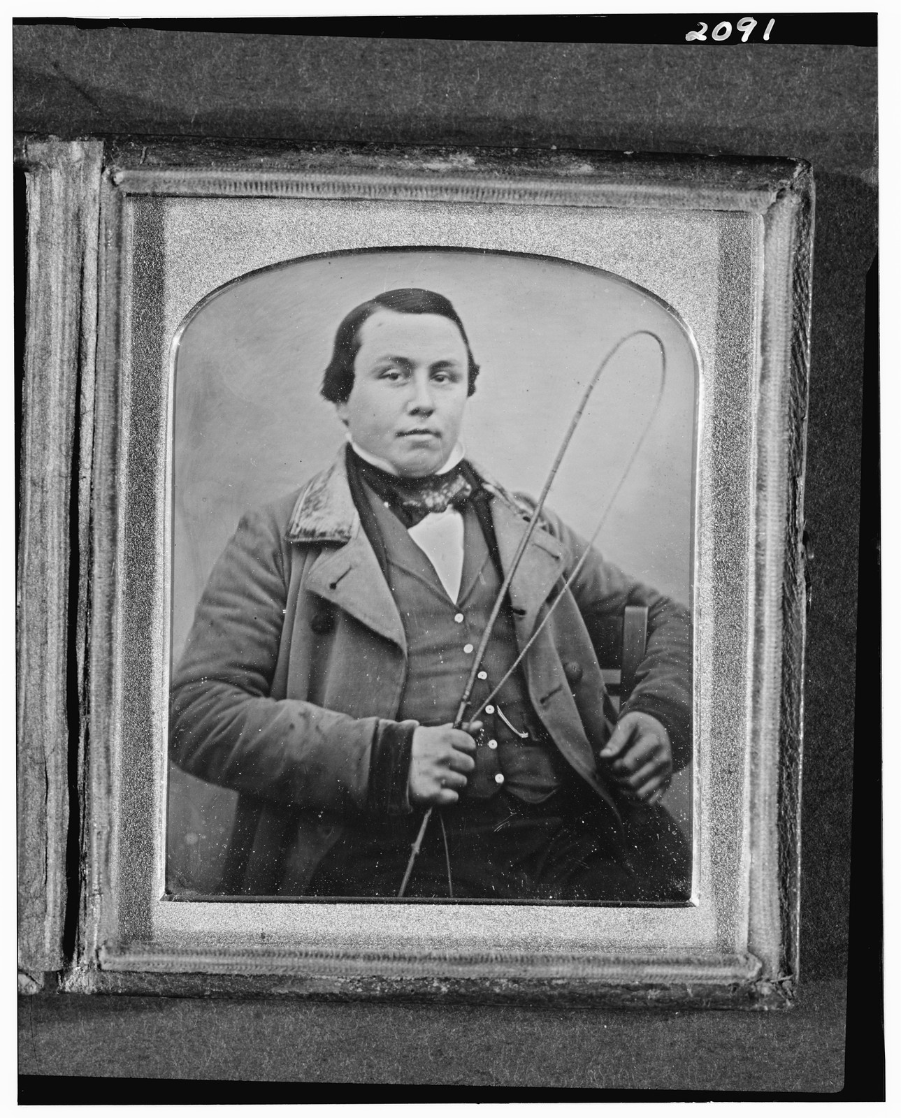 Daguerreotype portrait of a seated man holding a whip, 1850 — historic photograph
