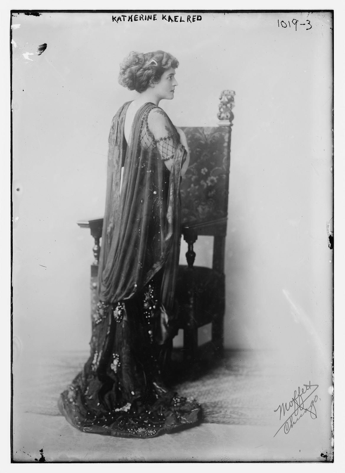 Katherine Kaelred standing before chair, Moffett Studio in Chicago / Moffett Studio, 1910 — historic photograph