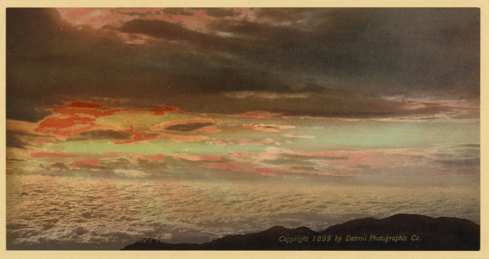 Hand-colored sunrise over clouds and mountain silhouette — historic image