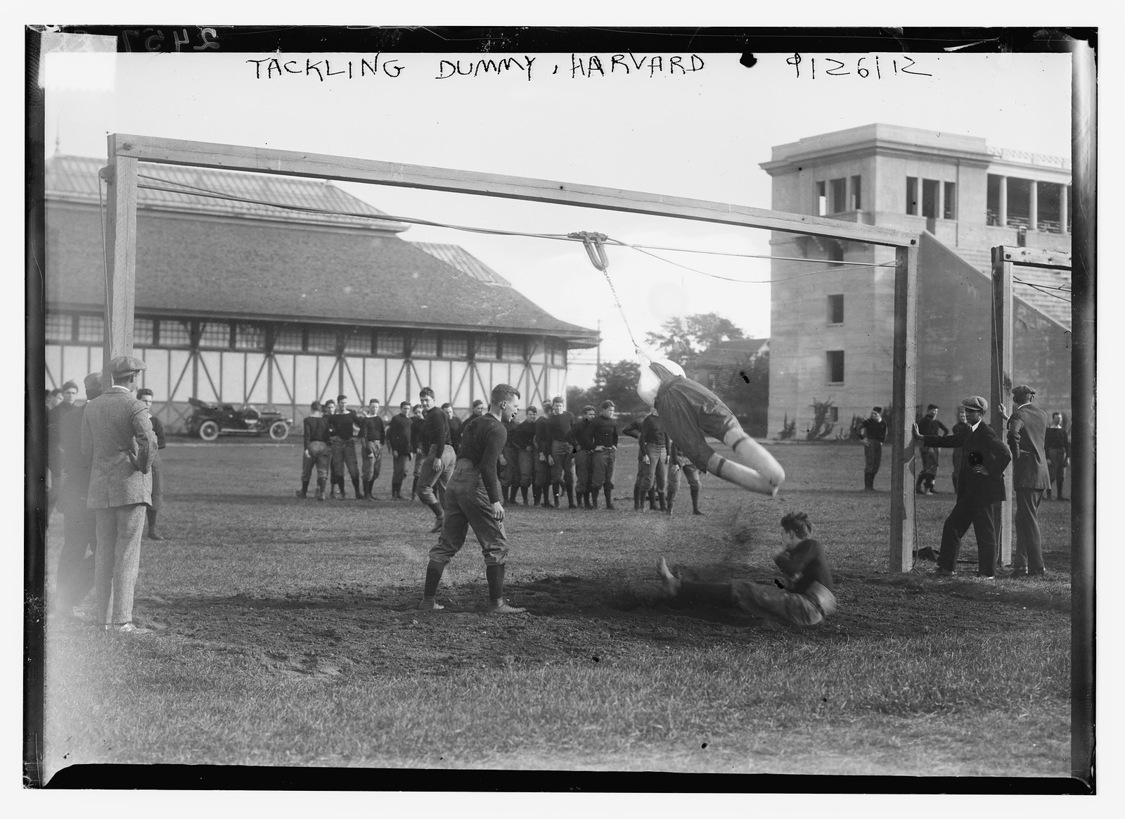 Tackling dummy, Harvard, 9/26/12 football team practicing, 09/26/1912. — historic photograph