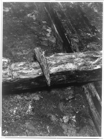 [Detail of railroad track showing wedge by which the longitudinal timber for carrying the iron rail was held in position on a crosstie]