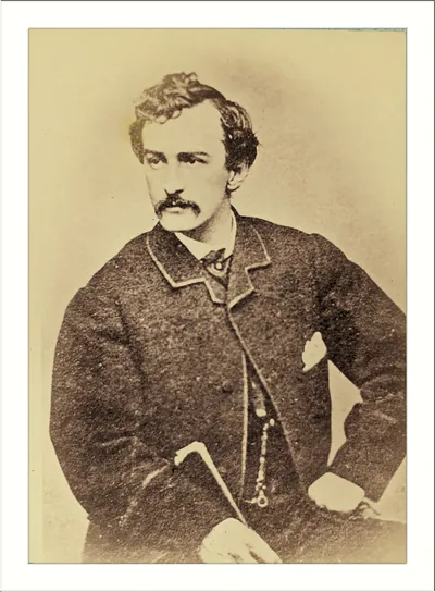 Sepia portrait photograph of a mustached man in a dark coat