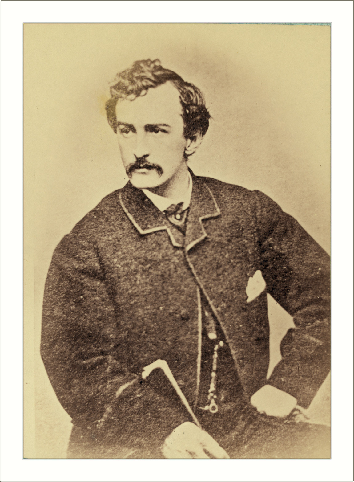 Sepia portrait photograph of a mustached man in a dark coat — historic photograph
