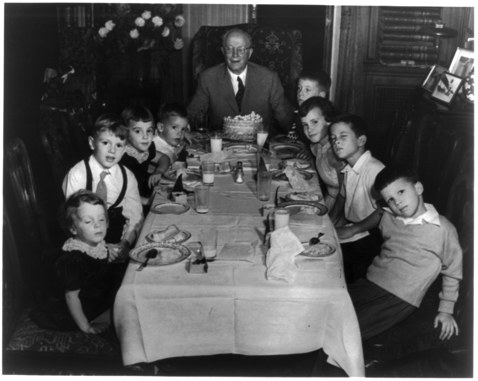 [Eugene Meyer with Graham grandchildren and others around dining room table at birthday party], [no date recorded on caption card] — historic photograph