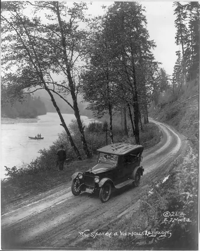 [Oregon - automobile in road beside fishing stream]