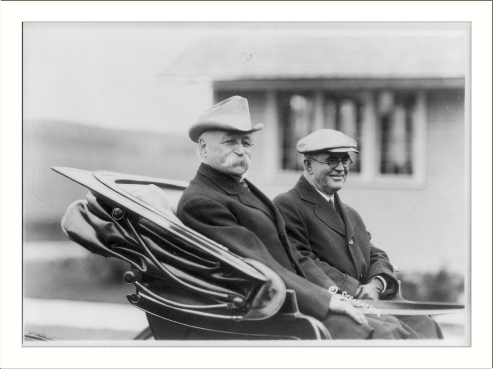 [County or state fair in New England: 2 men in back of open carriage] — historic photograph