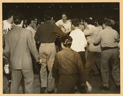 Players and crowd on a baseball field, Giants jersey visible